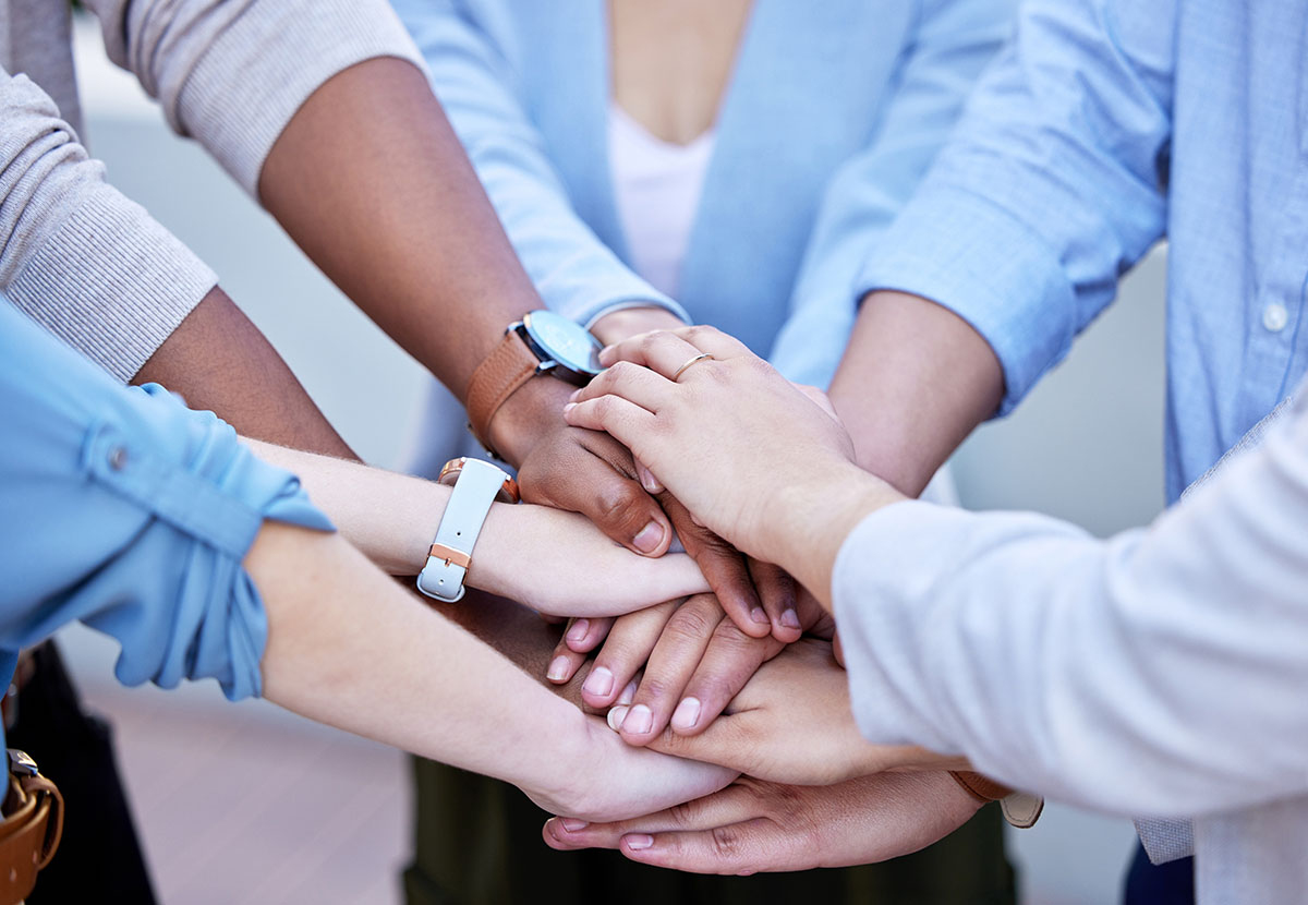 Uplifting one another to great success. Shot of a group of business people with their hands stacked. Uplifting one another to great success. Shot of a group of business people with their hands stacked.